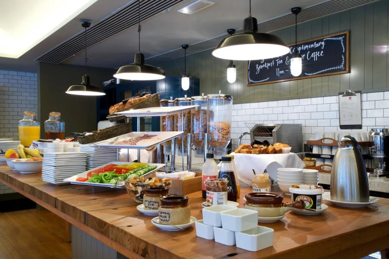 a buffet line with food on top of a counter at Bermondsey Square Hotel - A Bespoke Hotel in London