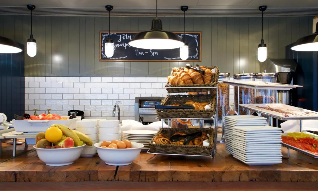 a kitchen with a bunch of food on a table at Bermondsey Square Hotel - A Bespoke Hotel in London